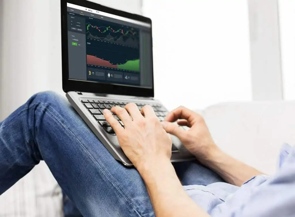 man who is trading cryptocurrency in his laptop