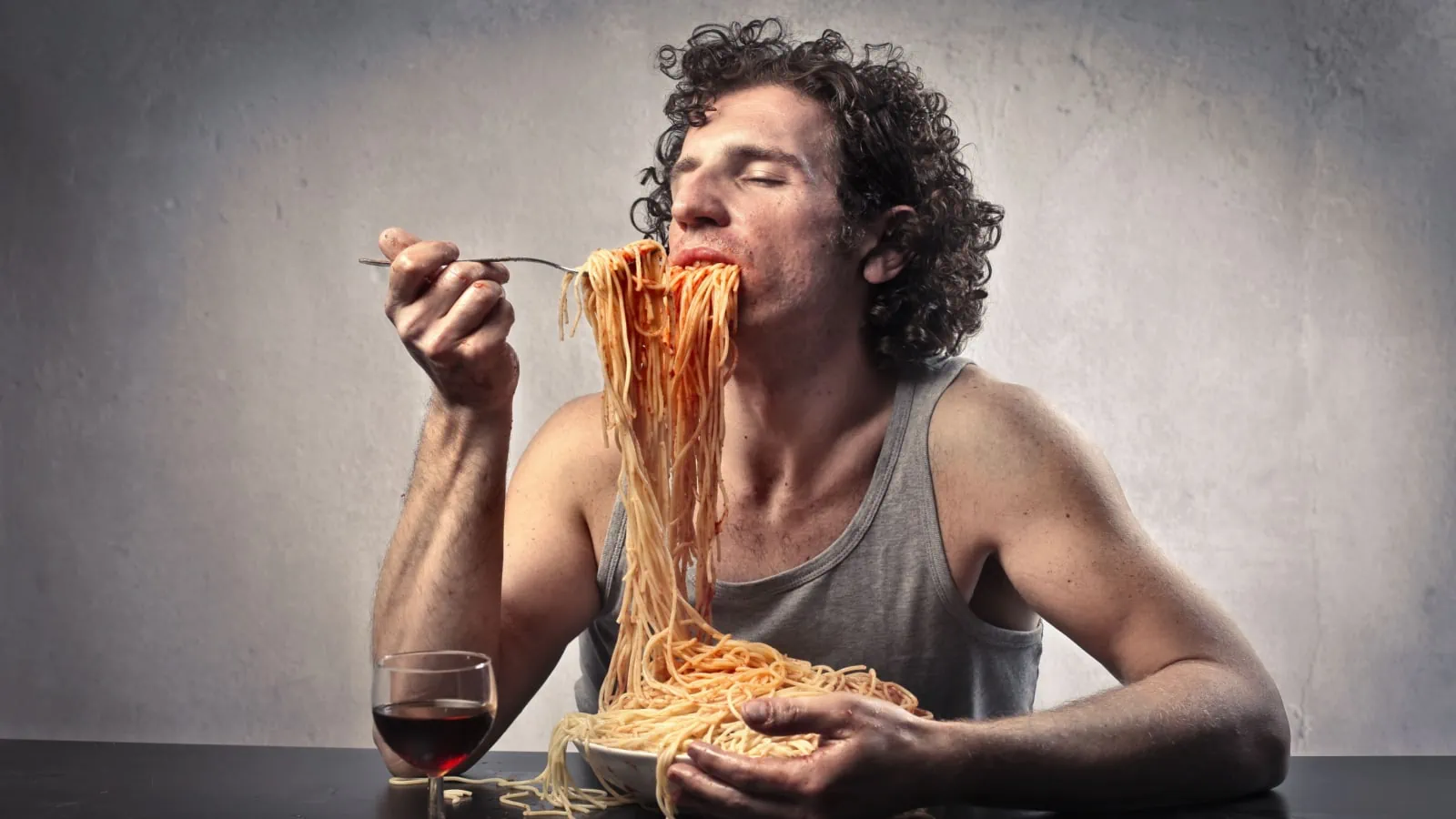 Man eating spaghetti messily