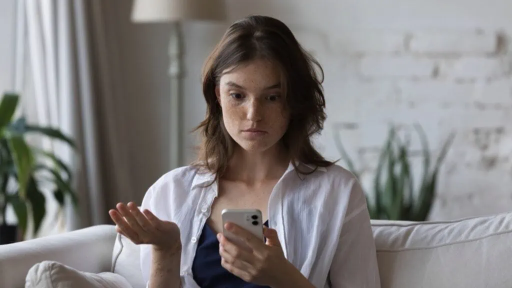 Woman seeing mobile and asking what