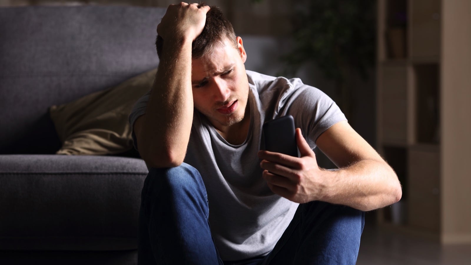 Stressed man checking mobile