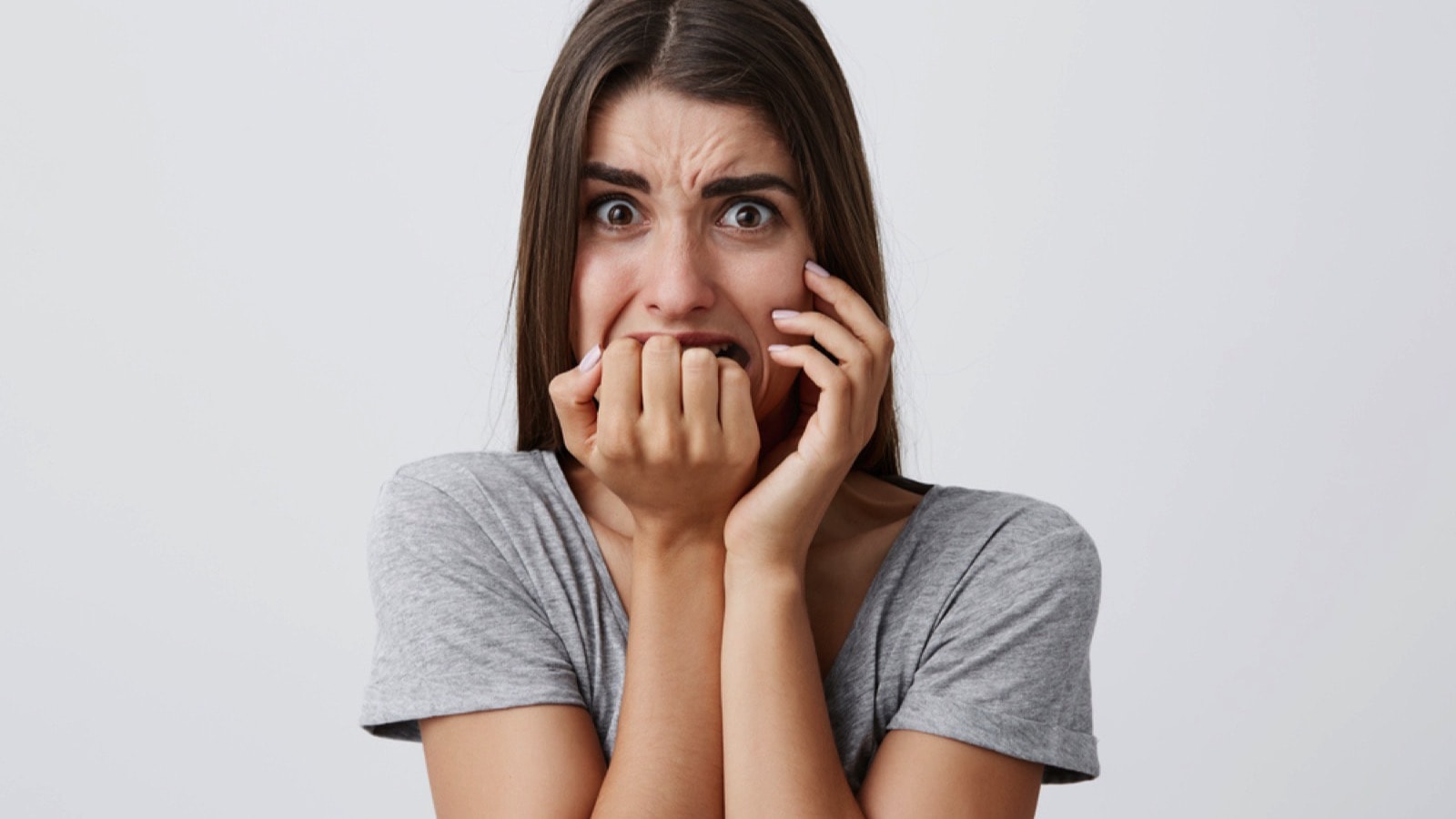 Unhappy young woman with scared expression