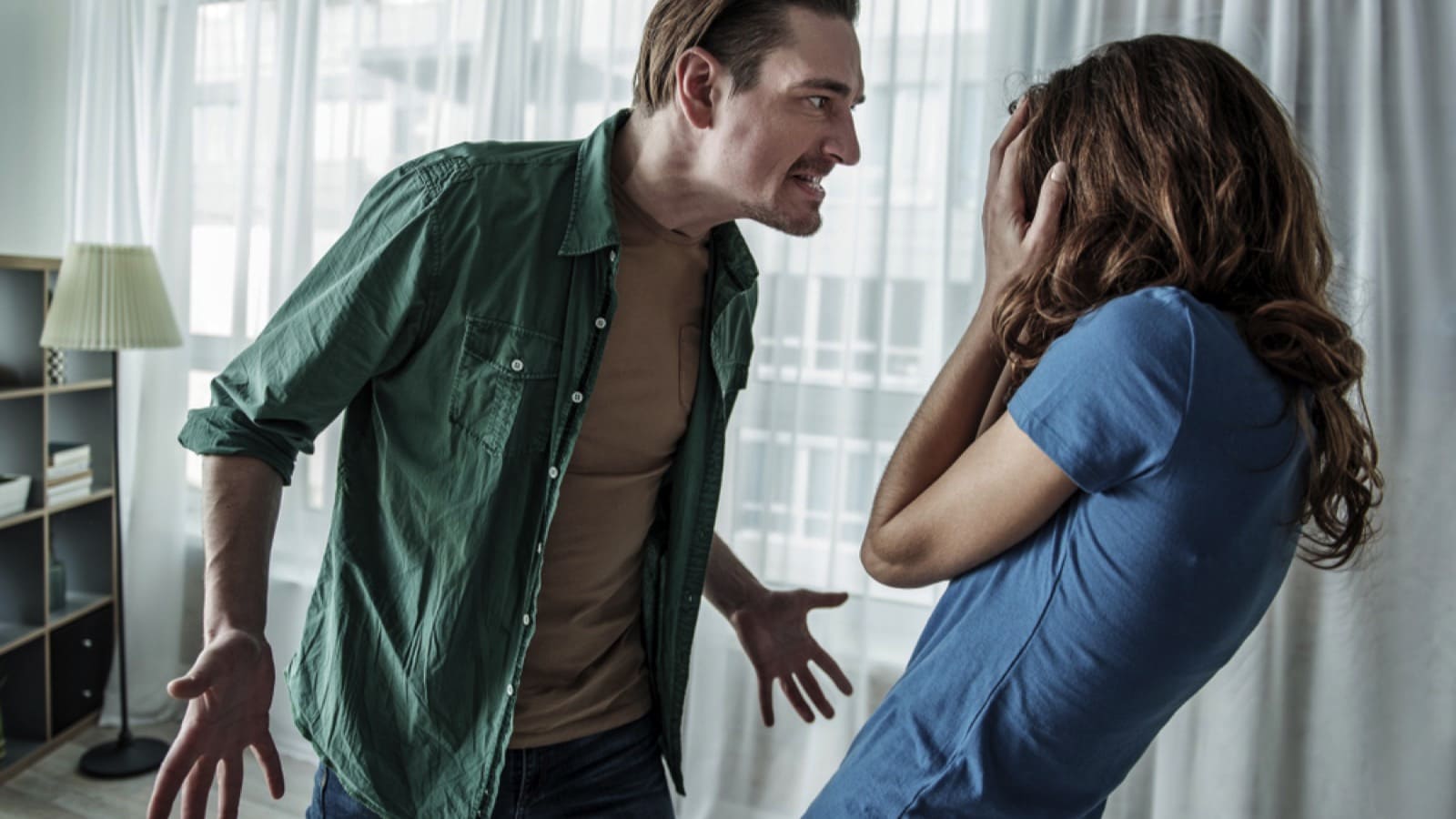 Irritated husband abusing woman