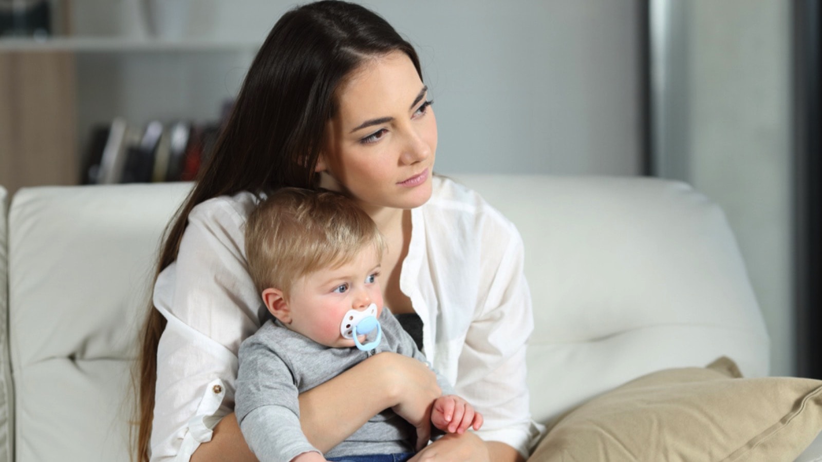 Sad woman looking away with child